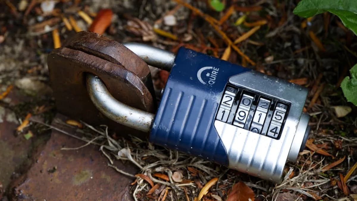 a closed padlock on a black surface